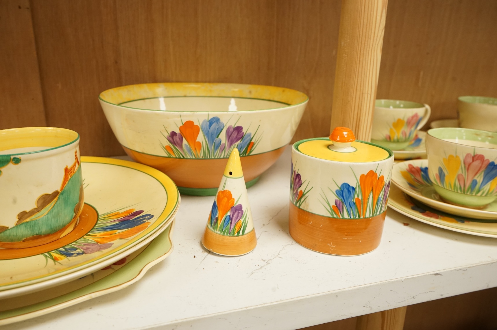 Collection of Clarice Cliff crocus pattern tea wares to include trios, milk jug, and a bowl, largest 22cm in diameter